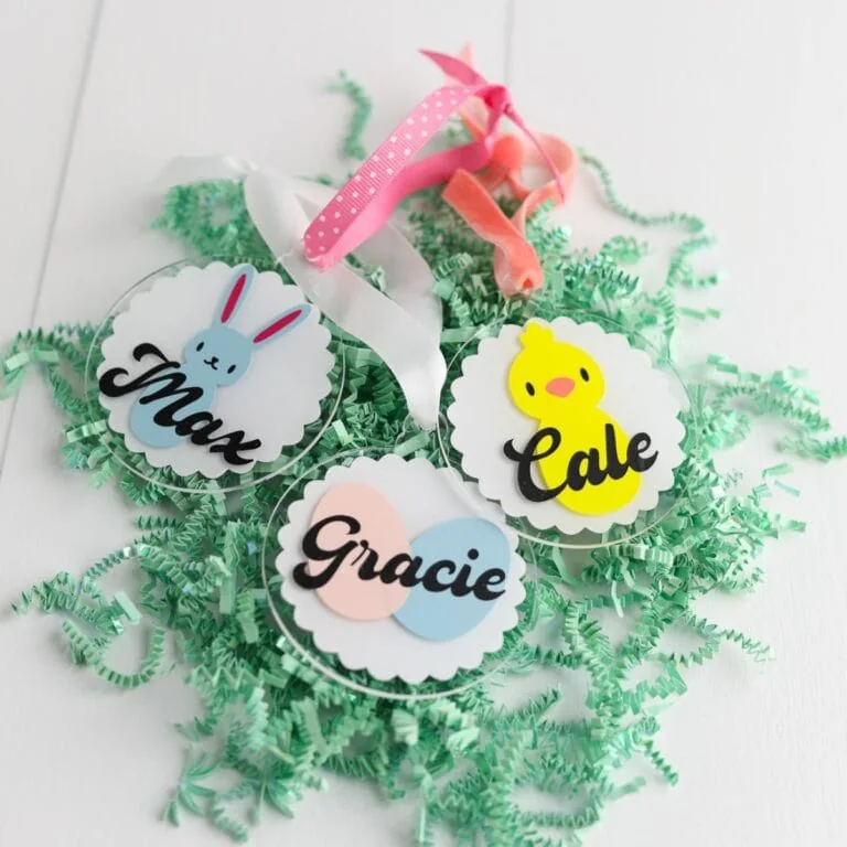 name tags for easter baskets on pile of paper grass