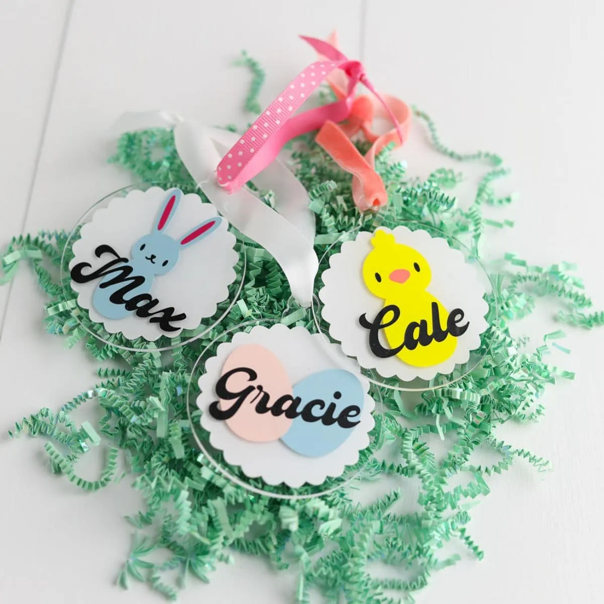 name tags for easter baskets on pile of paper grass