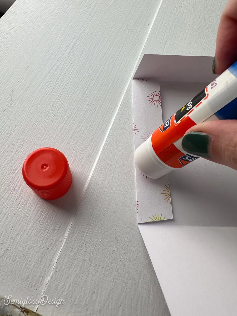 applying glue to envelope 