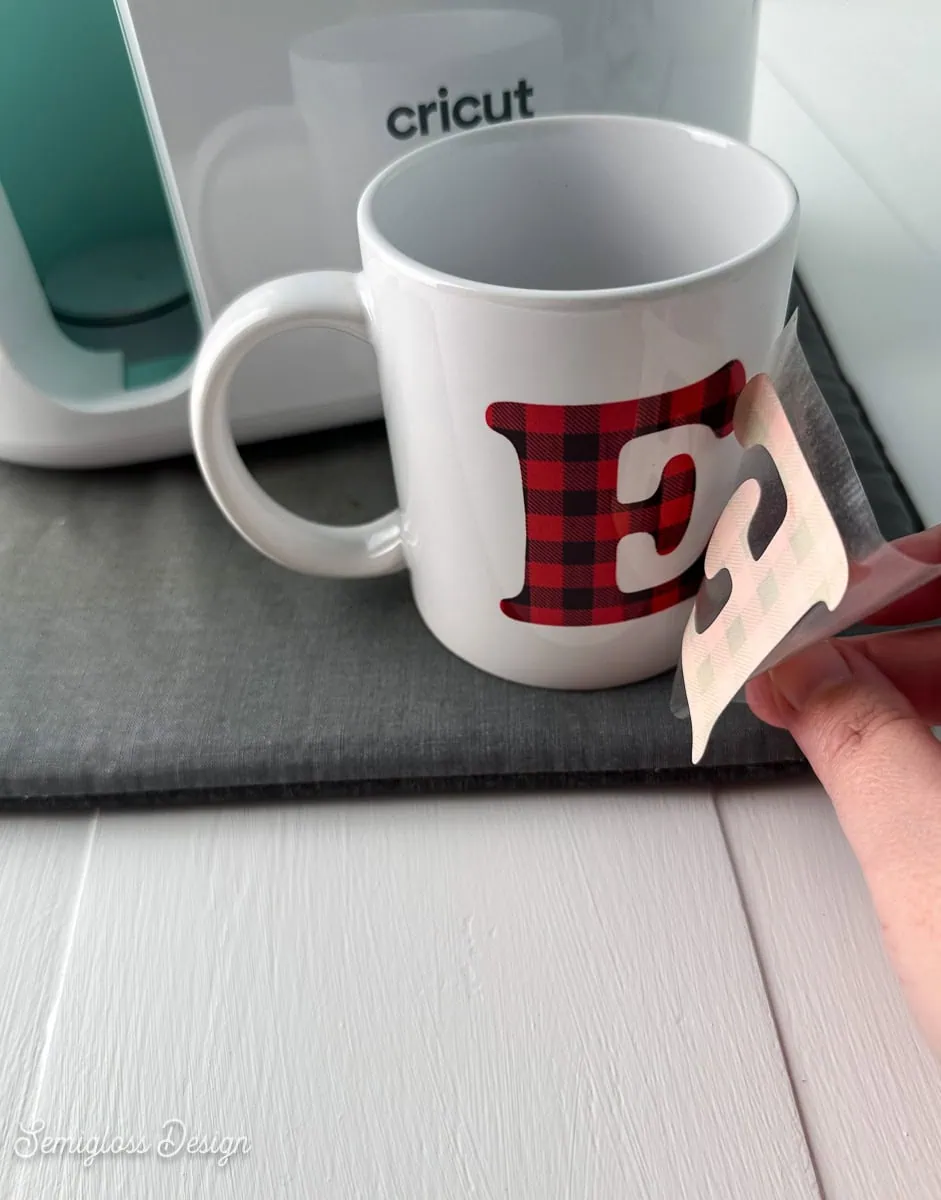 peeling off infusible ink sheet from finished mug
