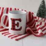 mug with buffalo check E on red striped towel