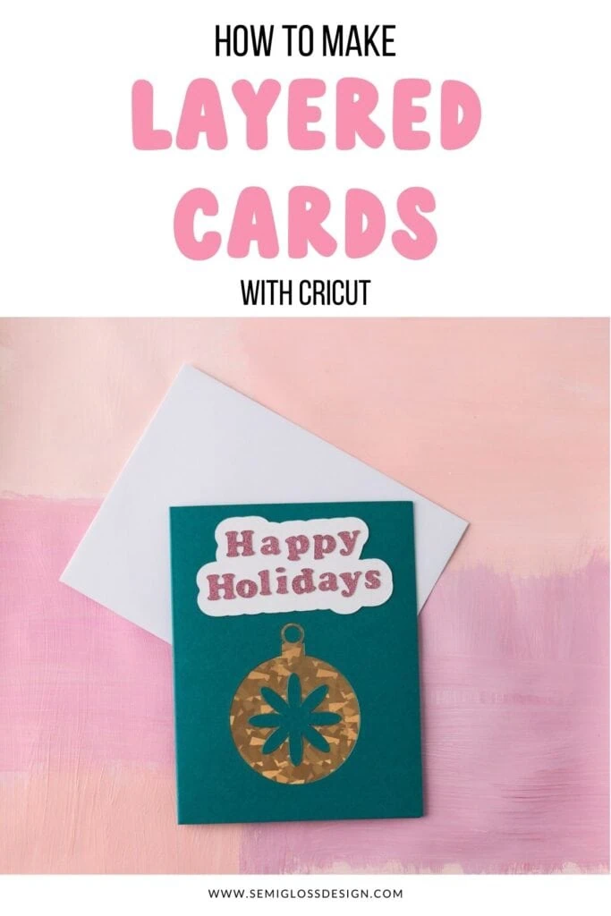 Teal card with gold ornament that says Happy Holidays in pink glitter
