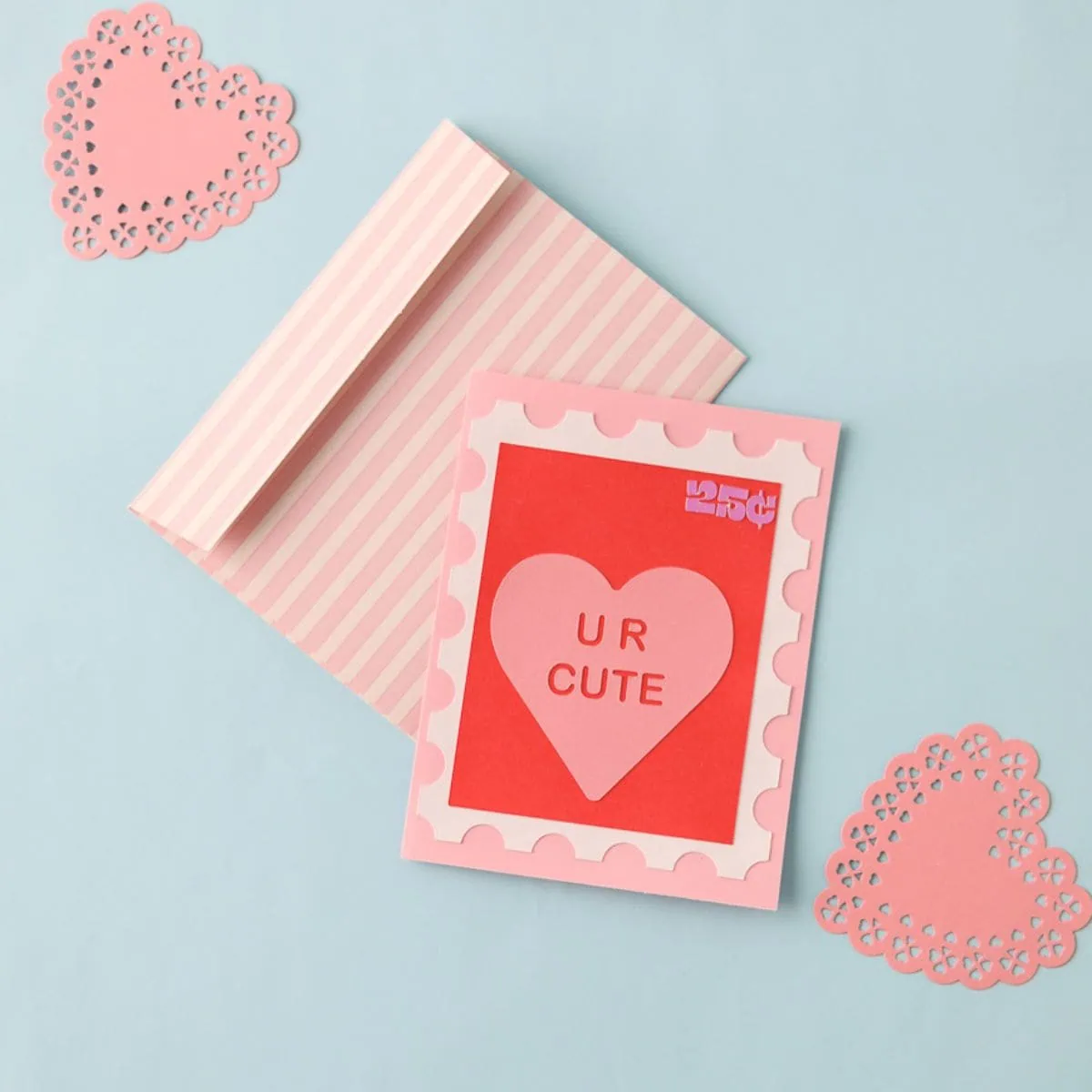 cute Valentine's day card featuring stamp design with conversation heart and striped pink envelope