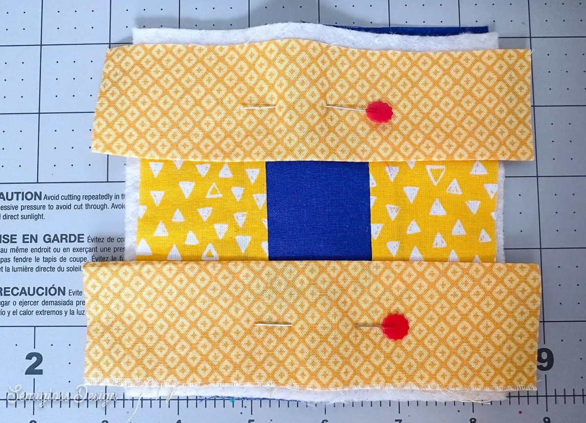 quilted coaster pinned to batting and backing