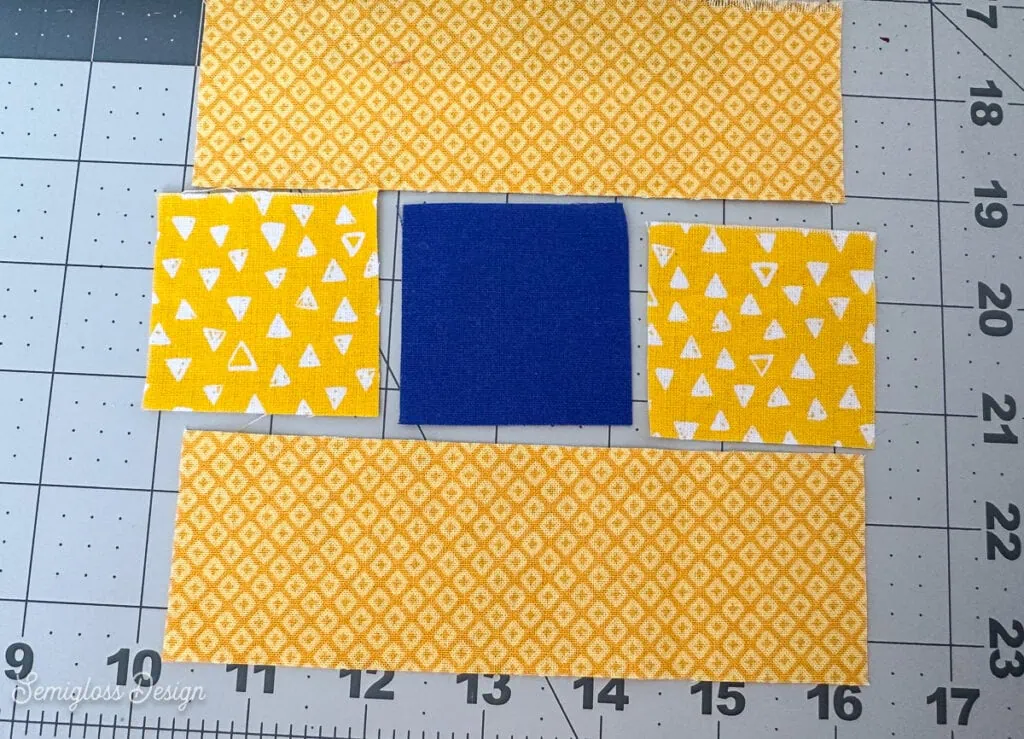 yellow and blue fabric laid out for coaster