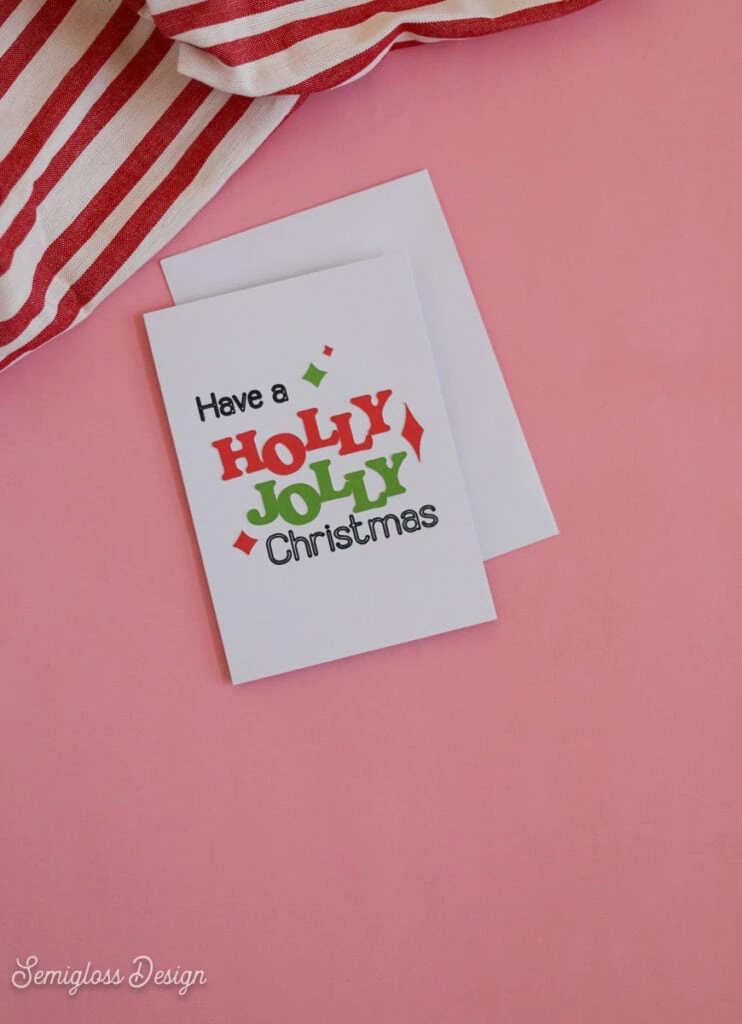 handmade Holly Jolly card on pink background
