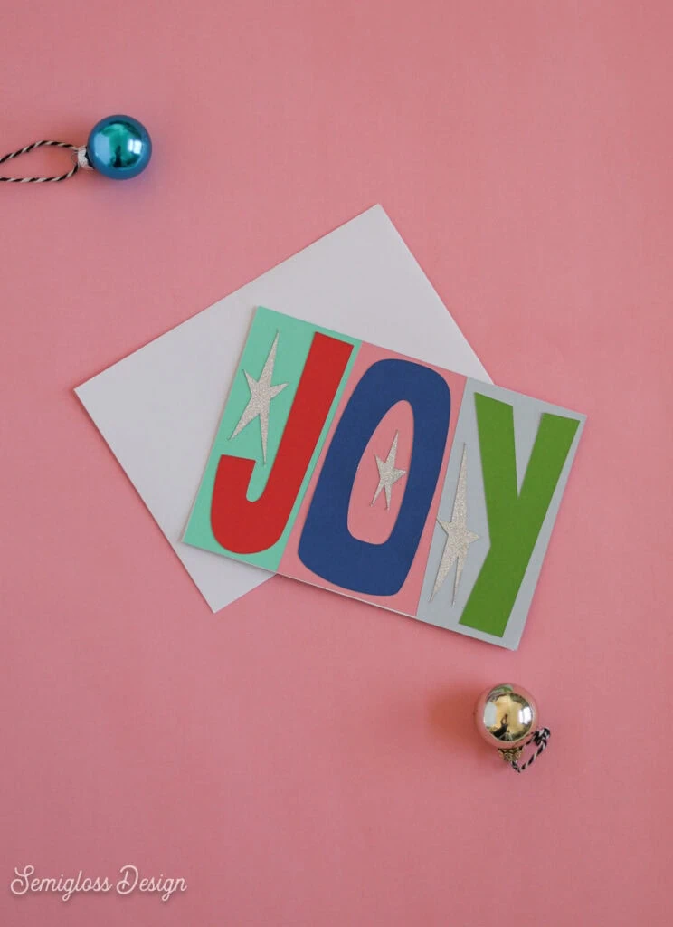 card that says Joy in cutout letters
