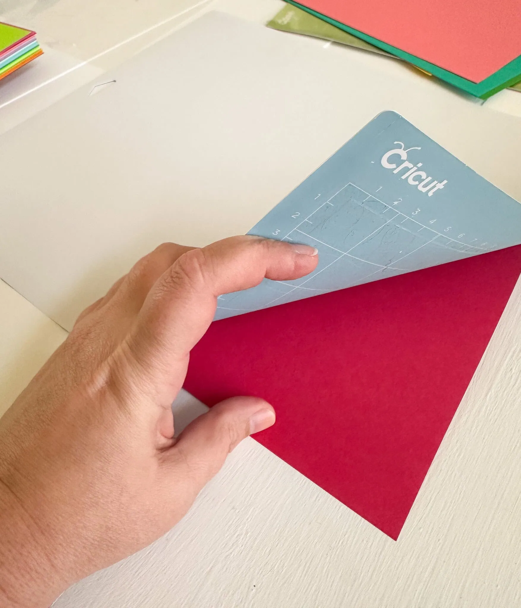 peeling cricut mat away from red paper