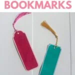 red and teal paper bookmarks on white wood background