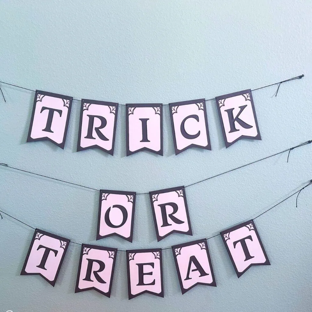 trick or treat paper banner on aqua wall