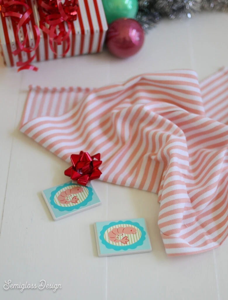 shrimp magnet and pink striped tea towel
