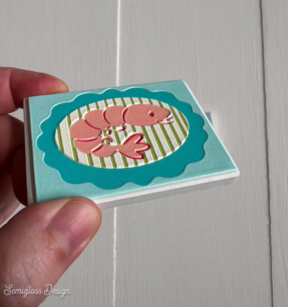 hand holding shrimp magnet showing texture