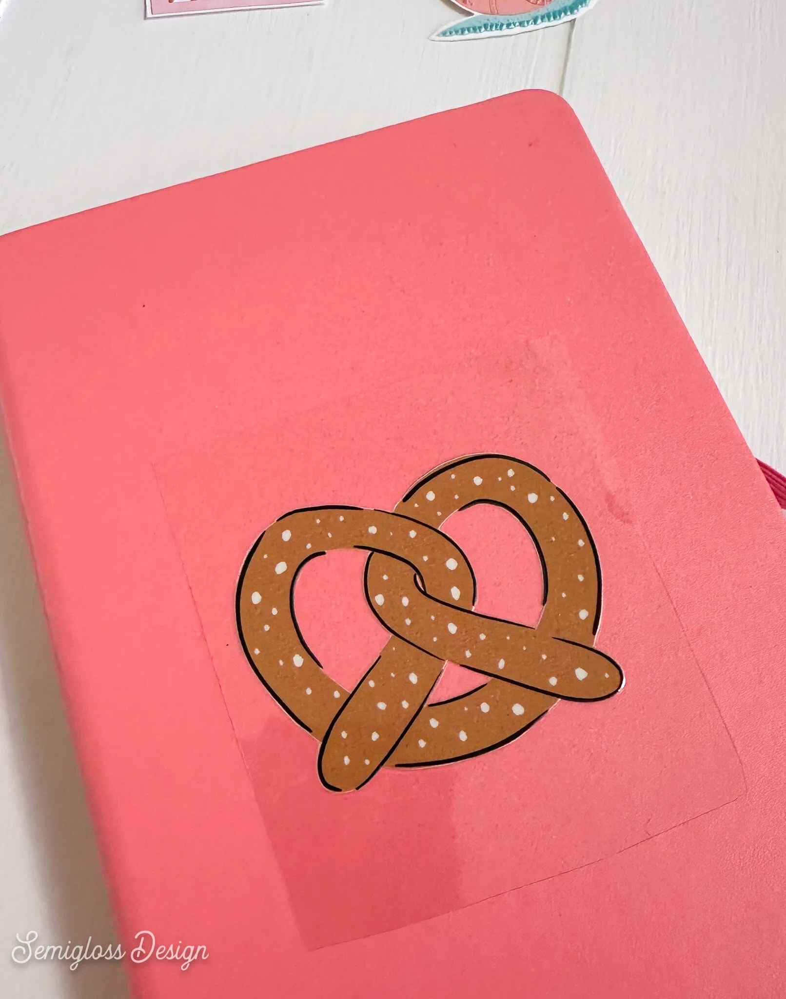 pretzel dtf decal sticker on pink journal